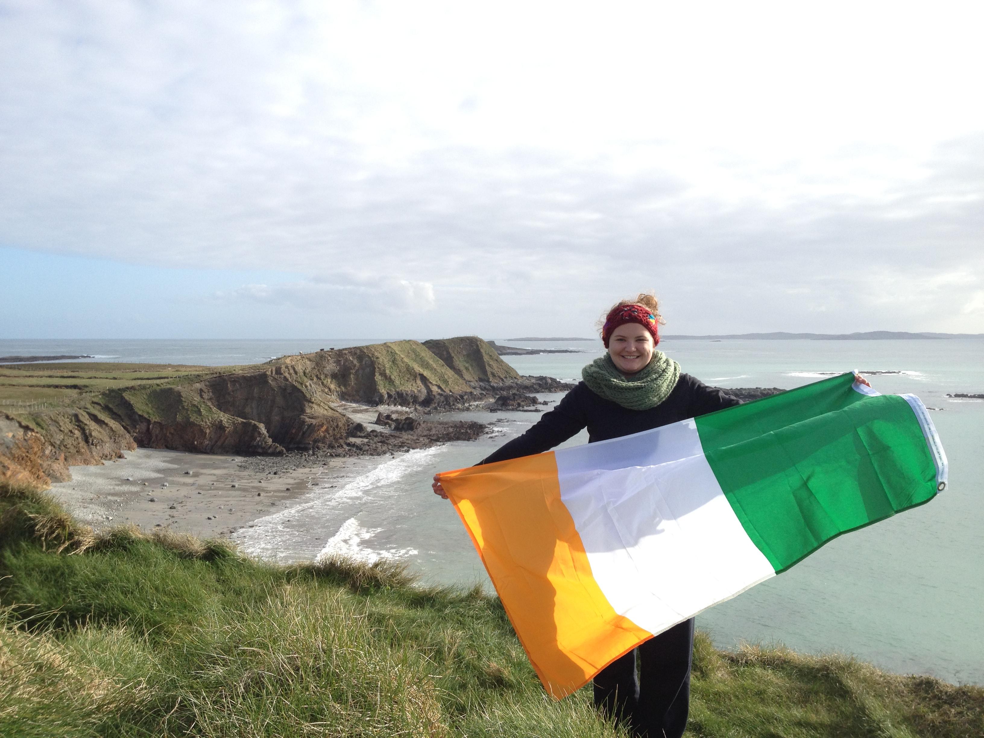 student holding an irish flag