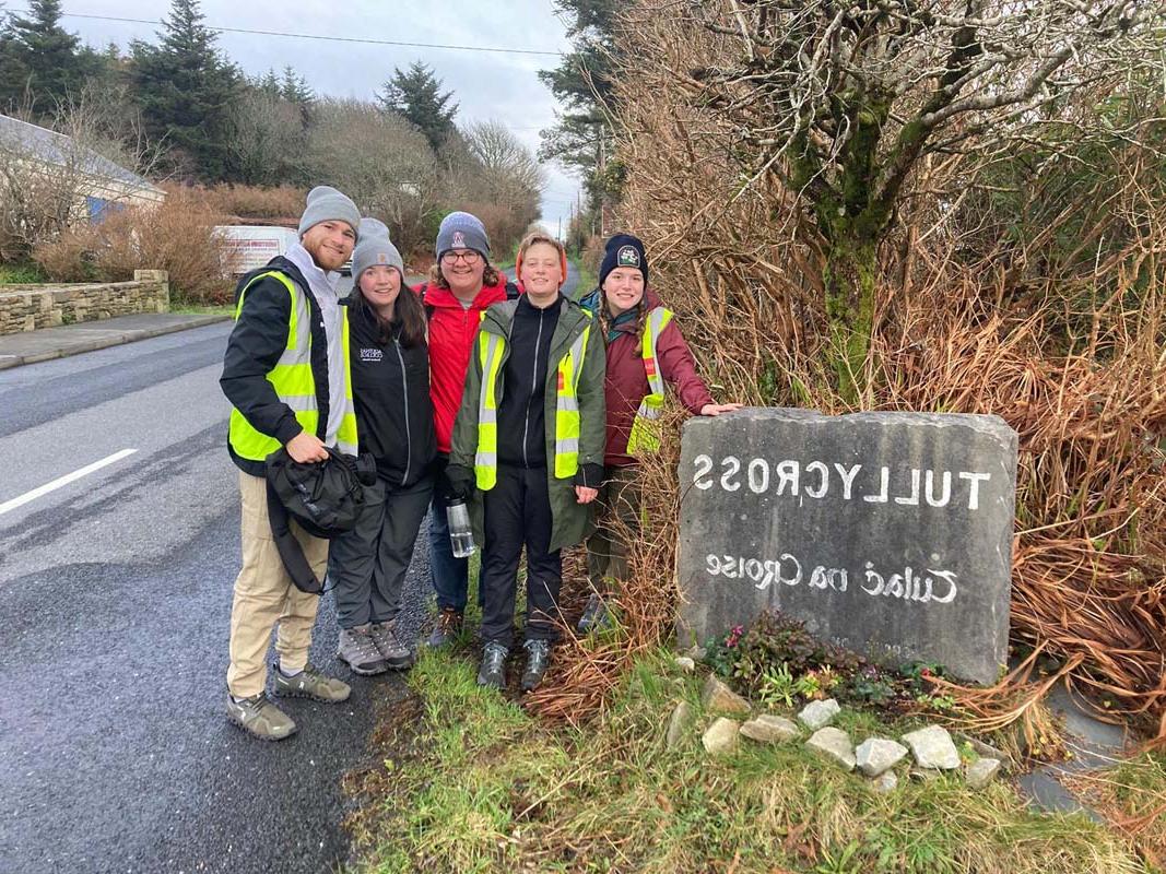 Students with rock carved to read Tully Cross Tulach Na Croise