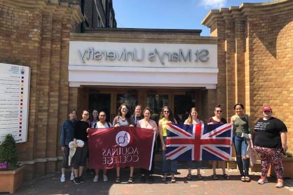 Students in front of St. Mary's University with an Aquinas flag and British Flag
